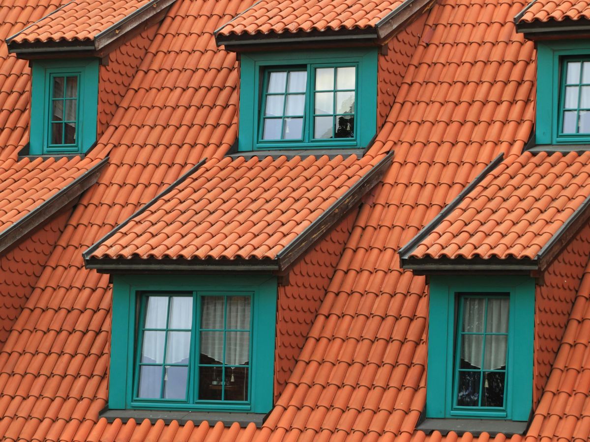 Brick roof house with green shade windows.