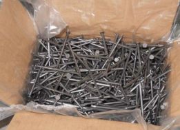Common nails packed in plastic to a box.