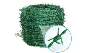 Rolled green colored barbed wire.