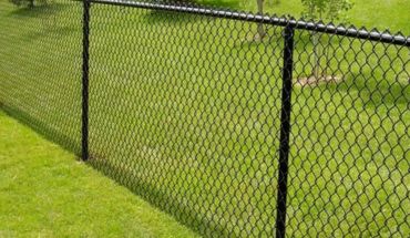 Field chain link fence galvanized iron wire mesh in a soccer field.