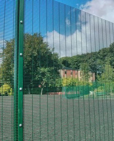 Galvanized wire mesh fence in a field.