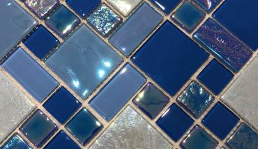 Iridescent glass mosaic tiles splash back with mesh-back design tiles.