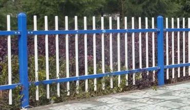 Iron metal blue and white metal garden fence.