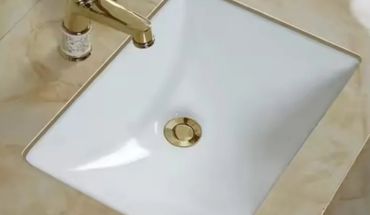 Rectangular undermount wash basin in gold splash.