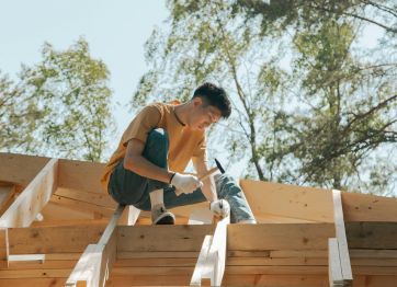 Carpenter using roofing nails for fixing roofs.