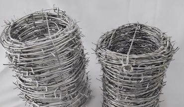 Single strand with double twist galvanized barbed wire rolls.