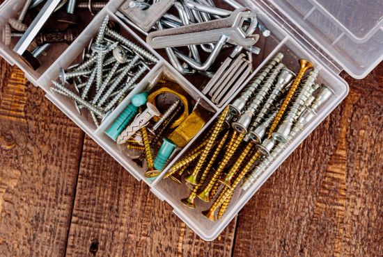 Different nails in a plastic box.