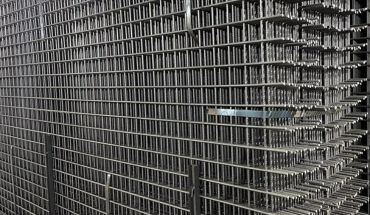 Welded mesh panel metal fence in silver hue.