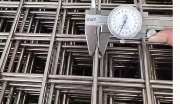 Welded wire mesh panel trench with measuring device.