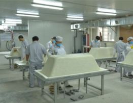 Bathtub molding by workers.