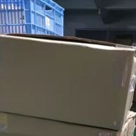 Boxed lighting and bulb in a factory.