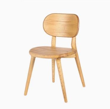 Classic wooden dining chairs in neutral accent.