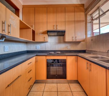 Kitchen wood cabinet in U shaped kitchen.