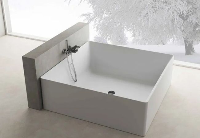 Large square freestanding mobile bathtub.