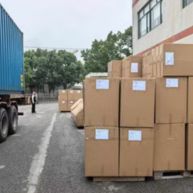 Packaged dining chairs outside factory.