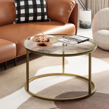 Round gold metal and glass coffee table stylistic design.