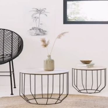 Round industrial coffee table with artistic design.