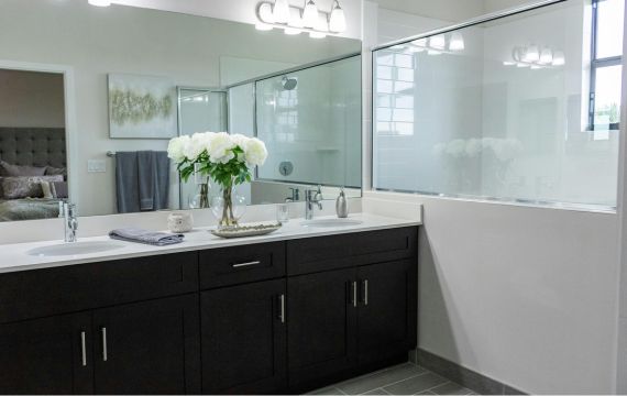 Vanities with black cabinets.