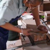 Worker polishing coffee table.