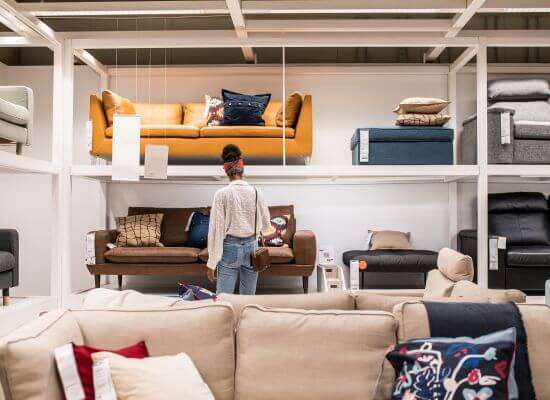 Expert inspecting furniture manufacturing sofa samples.